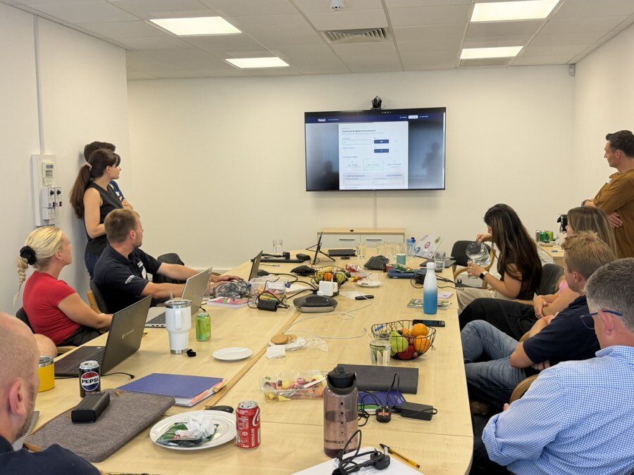 The Meech International team watching a demo during their AI hack day in Witney